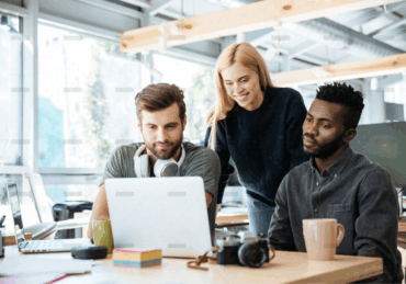 demo-attachment-888-happy-colleagues-sitting-in-office-coworking-PHYA6TG